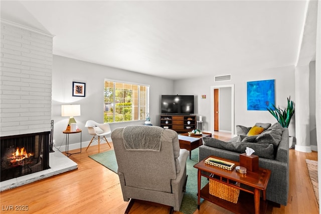 639 Lacy Ln, Las Vegas, NV 89107 - living area featuring a fireplace and wood finished floors