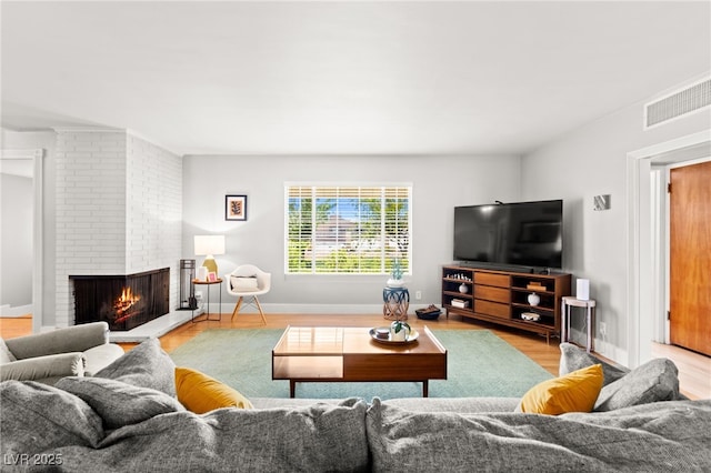 639 Lacy Ln, Las Vegas, NV 89107 - living room featuring a brick fireplace and wood finished floors