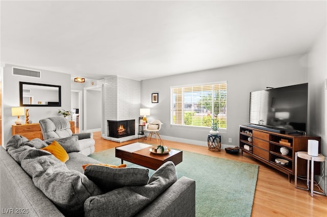 639 Lacy Ln, Las Vegas, NV 89107 - living area with light wood finished floors and a fireplace