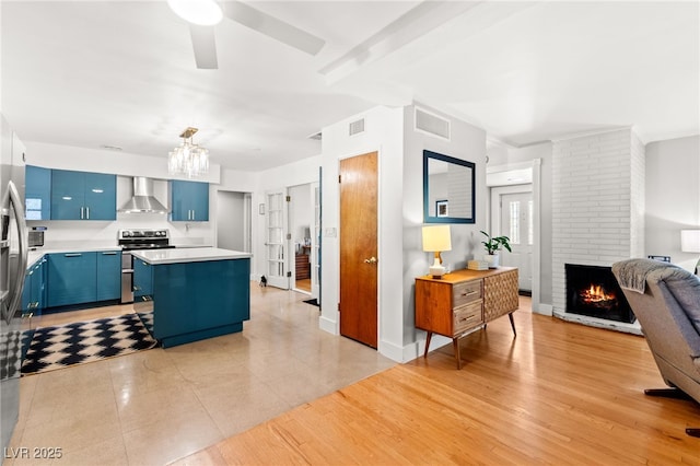 639 Lacy Ln, Las Vegas, NV 89107 - kitchen with blue cabinetry, light countertops, a center island, open floor plan, and a chandelier