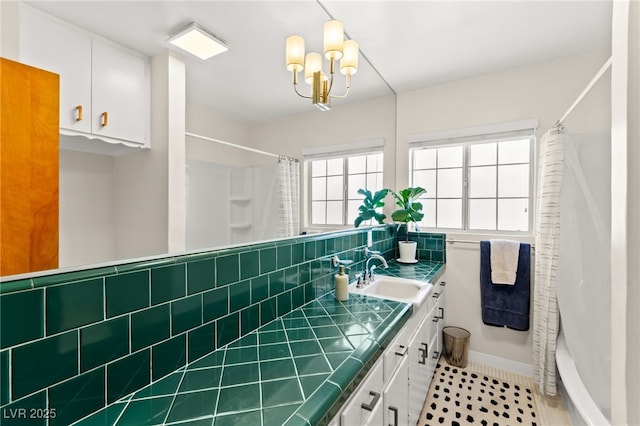639 Lacy Ln, Las Vegas, NV 89107 - bathroom featuring vanity, a chandelier, and shower / bath combo
