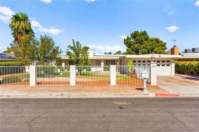 639 Lacy Ln, Las Vegas, NV 89107 - view of front of house featuring driveway, a fenced front yard, and a garage