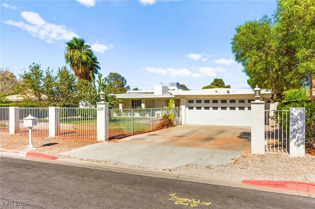 639 Lacy Ln, Las Vegas, NV 89107 - view of front facade featuring a fenced front yard, concrete driveway, and stucco siding