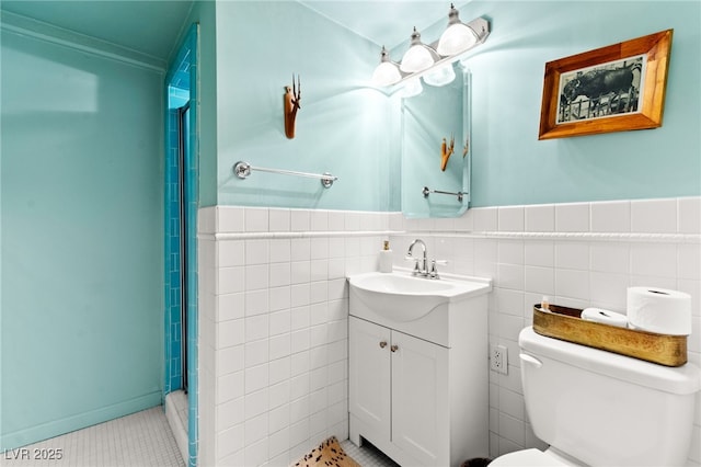 639 Lacy Ln, Las Vegas, NV 89107 - bathroom featuring vanity, tile walls, a wainscoted wall, a shower, and tile patterned flooring