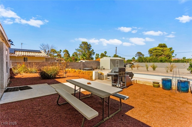 639 Lacy Ln, Las Vegas, NV 89107 - fenced backyard featuring a storage unit and a patio area