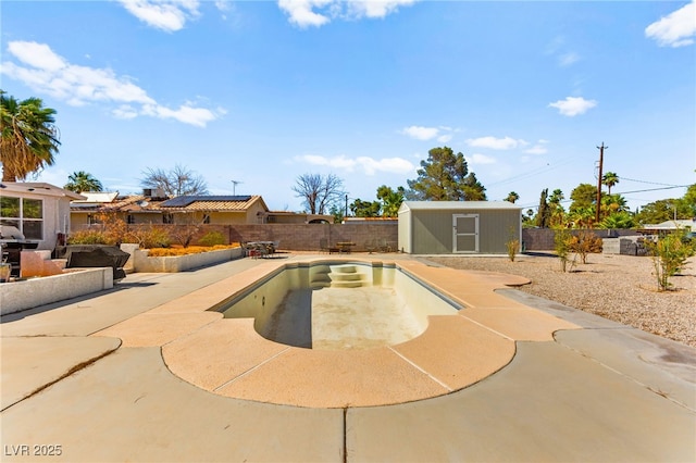 639 Lacy Ln, Las Vegas, NV 89107 - view of swimming pool with a fenced backyard, a patio, and a storage shed