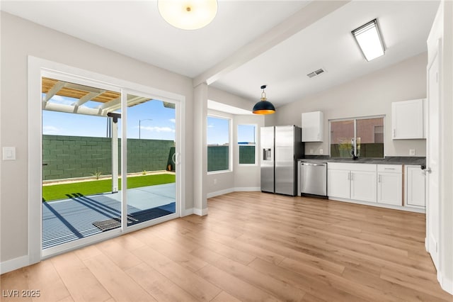 1904 Leaning Pine Way, Las Vegas, NV 89128 - kitchen featuring dark countertops, white cabinets, light wood finished floors, appliances with stainless steel finishes, and hanging light fixtures