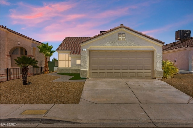 1904 Leaning Pine Way, Las Vegas, NV 89128 - mediterranean / spanish home featuring driveway, a tiled roof, stucco siding, and an attached garage