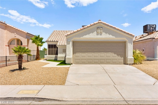 1904 Leaning Pine Way, Las Vegas, NV 89128 - mediterranean / spanish house featuring concrete driveway, stucco siding, a garage, and a tile roof