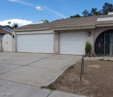 3214 Anacapa Way, Las Vegas, NV 89146 - garage featuring concrete driveway and a gate