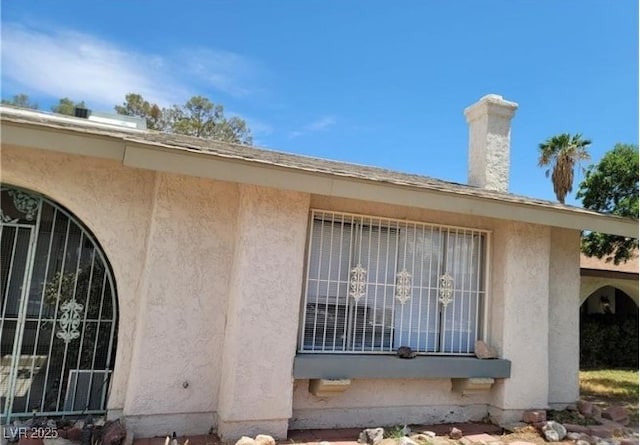 3214 Anacapa Way, Las Vegas, NV 89146 - view of side of home featuring stucco siding and a chimney