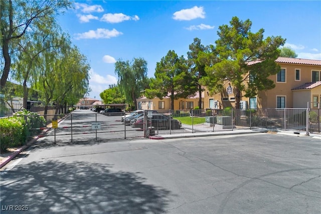 2060 Rancho Lake Dr Unit 103, Las Vegas, NV 89108 - view of asphalt street featuring a gate, curbs, a gated entry, and sidewalks
