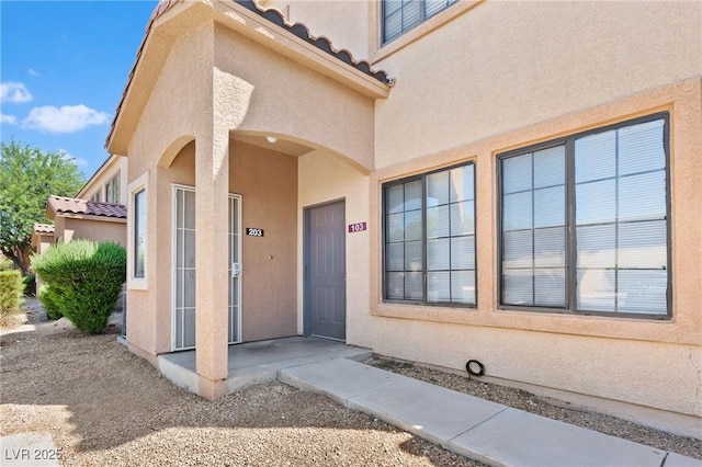 2060 Rancho Lake Dr Unit 103, Las Vegas, NV 89108 - doorway to property with a tile roof and stucco siding