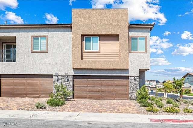 906 Cadence View Way, Henderson, NV 89011 - view of front facade with stone siding, a garage, stucco siding, and decorative driveway