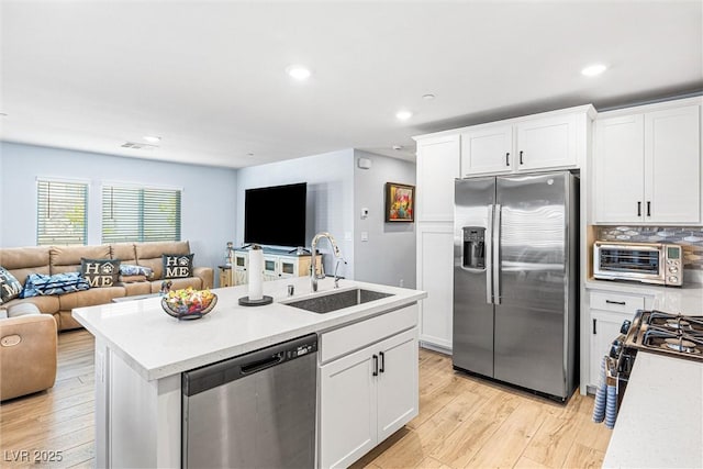 906 Cadence View Way, Henderson, NV 89011 - kitchen with stainless steel appliances, open floor plan, white cabinets, light wood-type flooring, and recessed lighting