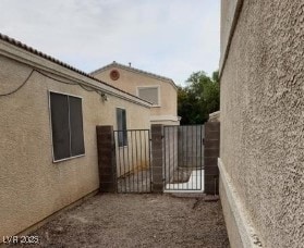 3254 Gold Run St, North Las Vegas, NV 89032 - view of property exterior featuring stucco siding and a gate
