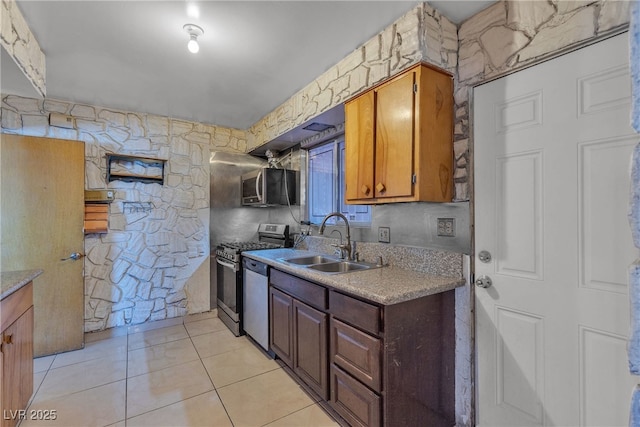 4709 Alpine Pl, Las Vegas, NV 89107 - kitchen with appliances with stainless steel finishes, light countertops, light tile patterned flooring, and brown cabinetry