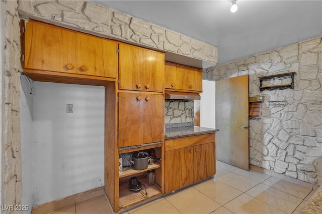4709 Alpine Pl, Las Vegas, NV 89107 - kitchen featuring brown cabinetry, light tile patterned floors, and light countertops