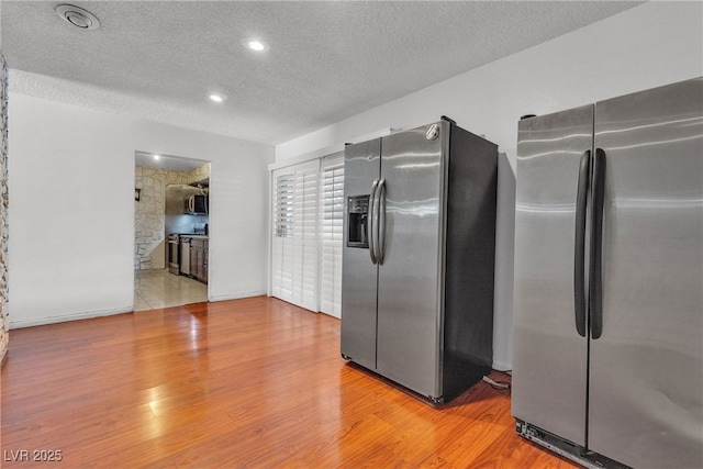 4709 Alpine Pl, Las Vegas, NV 89107 - kitchen featuring stainless steel appliances, a textured ceiling, wood finished floors, and recessed lighting