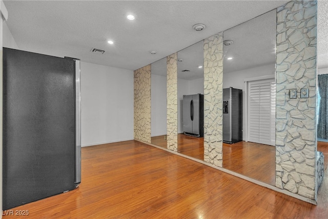 4709 Alpine Pl, Las Vegas, NV 89107 - spare room featuring decorative columns, wood finished floors, a textured ceiling, and recessed lighting
