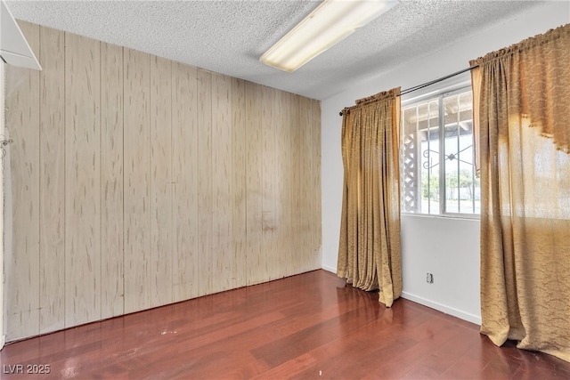 4709 Alpine Pl, Las Vegas, NV 89107 - spare room with wooden walls, wood finished floors, and a textured ceiling