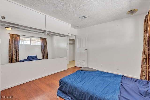 4709 Alpine Pl, Las Vegas, NV 89107 - bedroom featuring a textured ceiling and wood finished floors