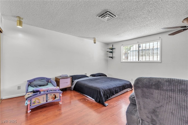 4709 Alpine Pl, Las Vegas, NV 89107 - bedroom featuring a textured ceiling and wood finished floors