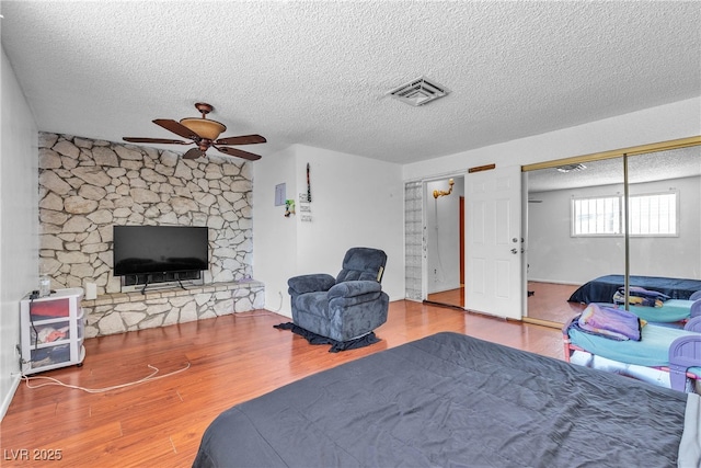 4709 Alpine Pl, Las Vegas, NV 89107 - bedroom with a textured ceiling, wood finished floors, and ceiling fan