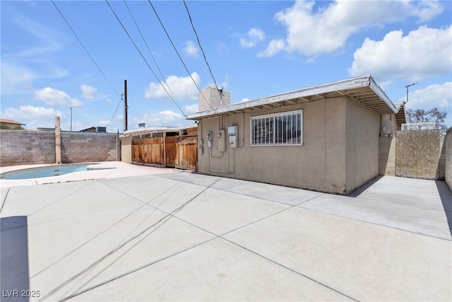 4709 Alpine Pl, Las Vegas, NV 89107 - back of property featuring a patio, a fenced backyard, stucco siding, and a chimney