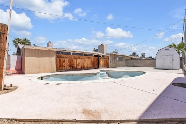4709 Alpine Pl, Las Vegas, NV 89107 - view of pool with a storage unit, a fenced backyard, and a patio