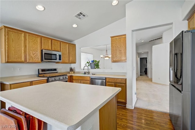 5630 Midnight Breeze St, North Las Vegas, NV 89081 - kitchen with appliances with stainless steel finishes, vaulted ceiling, light countertops, dark wood-type flooring, and recessed lighting