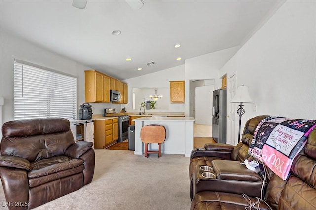 5630 Midnight Breeze St, North Las Vegas, NV 89081 - living area with vaulted ceiling, light colored carpet, and recessed lighting
