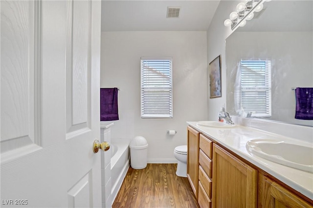 5630 Midnight Breeze St, North Las Vegas, NV 89081 - full bath featuring a garden tub, double vanity, plenty of natural light, and wood finished floors