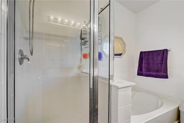 5630 Midnight Breeze St, North Las Vegas, NV 89081 - bathroom featuring a shower stall and a bath