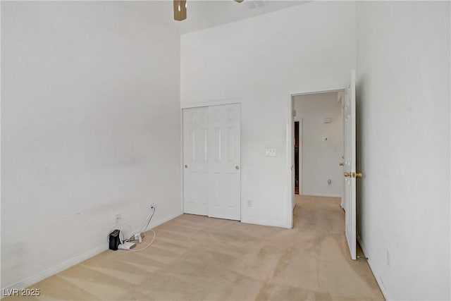 5630 Midnight Breeze St, North Las Vegas, NV 89081 - unfurnished room featuring light carpet, a ceiling fan, and a high ceiling