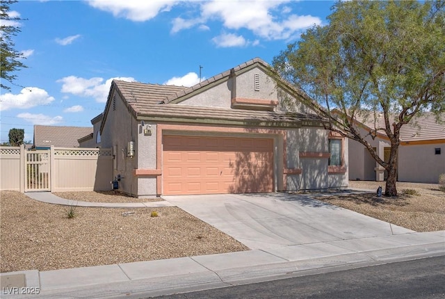 5630 Midnight Breeze St, North Las Vegas, NV 89081 - view of front of property with a garage, driveway, stucco siding, and a tile roof