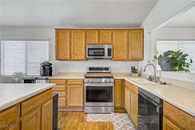 5630 Midnight Breeze St, North Las Vegas, NV 89081 - kitchen with stainless steel appliances, light countertops, and light wood-style floors