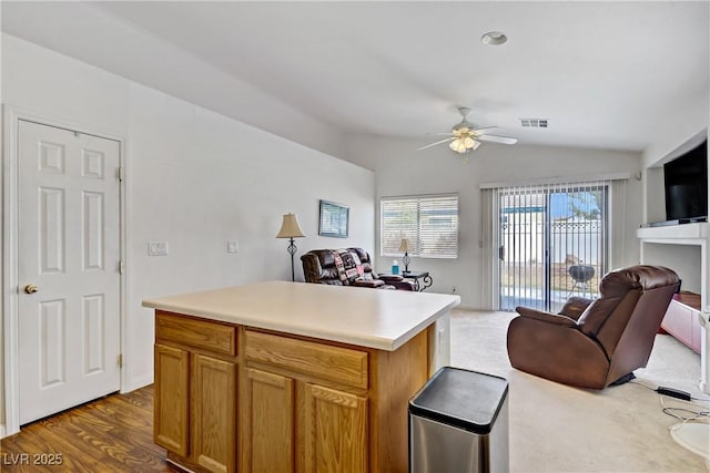 5630 Midnight Breeze St, North Las Vegas, NV 89081 - kitchen featuring open floor plan, a ceiling fan, vaulted ceiling, light countertops, and brown cabinets