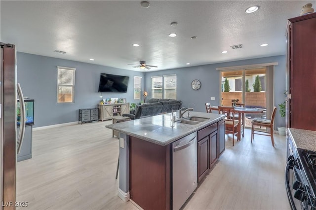 8104 Switchback Run St, Las Vegas, NV 89166 - kitchen with stainless steel appliances, light wood-type flooring, healthy amount of natural light, and recessed lighting