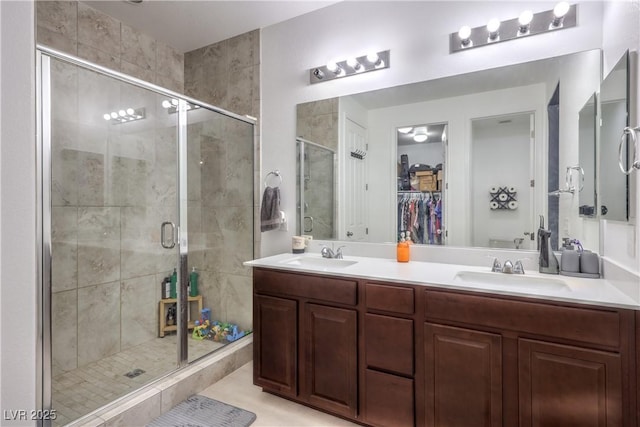 8104 Switchback Run St, Las Vegas, NV 89166 - bathroom featuring a shower stall, double vanity, and a spacious closet