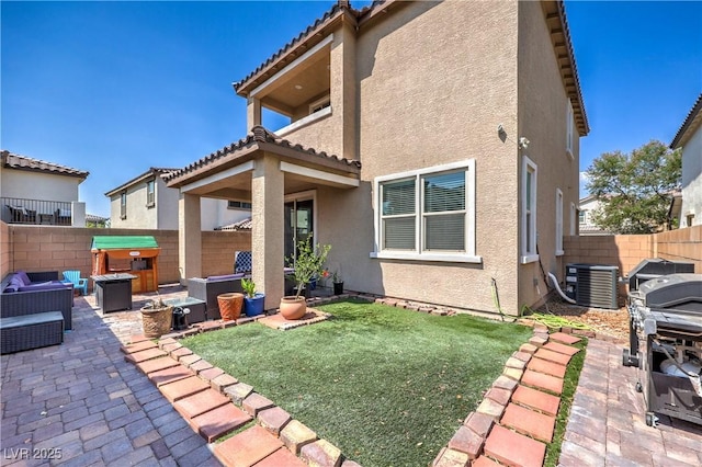 8104 Switchback Run St, Las Vegas, NV 89166 - back of property with a hot tub, a patio, a fenced backyard, stucco siding, and a tile roof