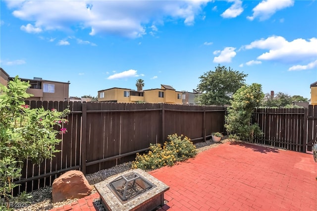 1467 Hialeah Dr Unit C, Las Vegas, NV 89119 - fenced backyard featuring a fire pit, a patio, and a residential view