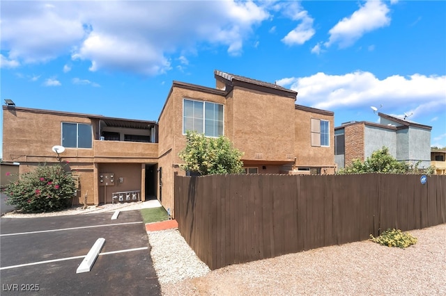 1467 Hialeah Dr Unit C, Las Vegas, NV 89119 - view of home's exterior featuring uncovered parking and stucco siding