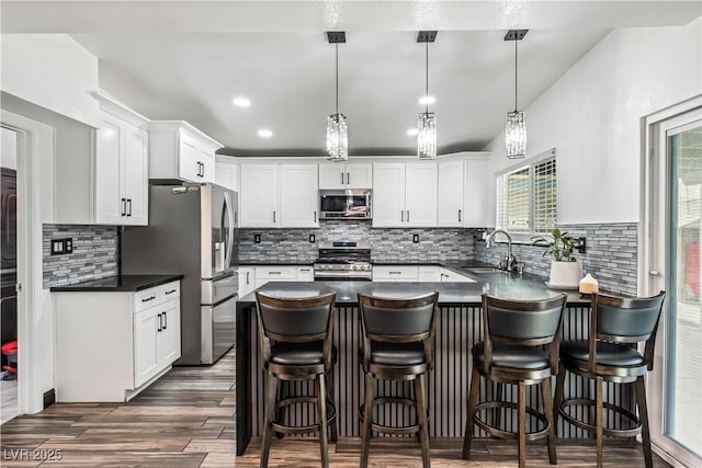 1905 Las Verdes St, Las Vegas, NV 89102 - kitchen featuring dark countertops, stainless steel appliances, backsplash, a peninsula, and recessed lighting