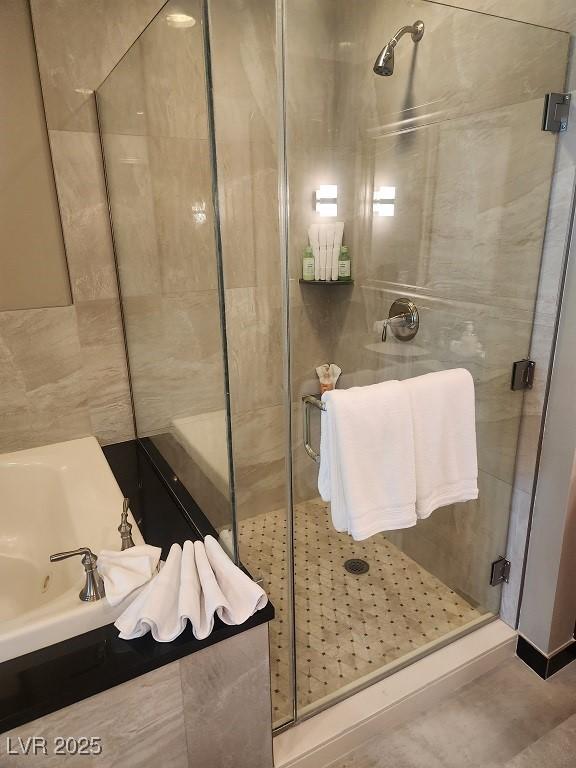 135 E Harmon Ave Unit 2621, Las Vegas, NV 89109 - full bath with a shower stall and a jetted tub