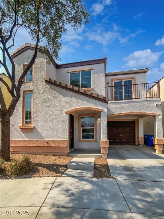 8872 Niche Ave, Las Vegas, NV 89149 - view of front of house featuring a balcony, driveway, stucco siding, and an attached garage