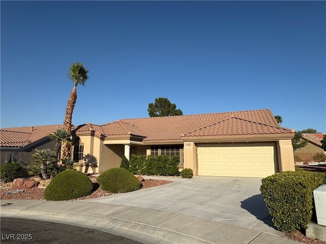 2406 Showcase Dr, Las Vegas, NV 89134 - view of front of home with stucco siding, concrete driveway, a garage, and a tiled roof