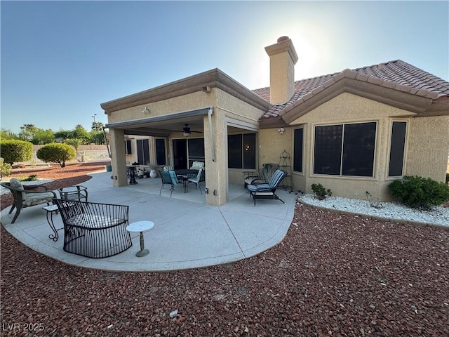 2406 Showcase Dr, Las Vegas, NV 89134 - rear view of house with ceiling fan, stucco siding, a patio, a tile roof, and a chimney