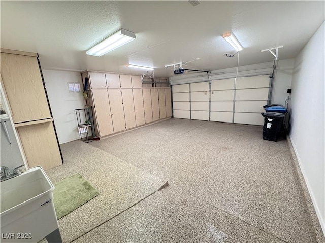 2406 Showcase Dr, Las Vegas, NV 89134 - garage featuring baseboards and a sink