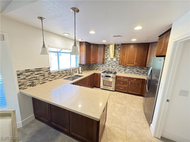 2406 Showcase Dr, Las Vegas, NV 89134 - kitchen with a peninsula, stainless steel appliances, tasteful backsplash, decorative light fixtures, and recessed lighting